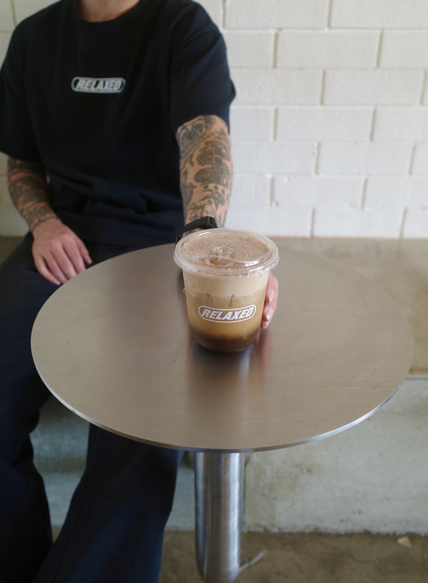 A Whittaker's Mont Blanc shake in a branded Relaxed cup on a steel table